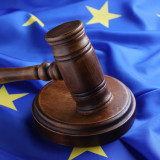 Wooden judge's gavel on flag