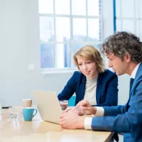 man-en-vrouw-in-gesprek-bij-laptop_accountancy