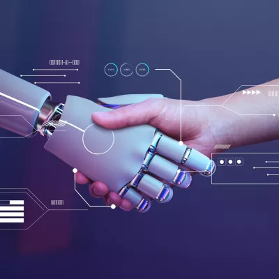 Mensenhand en robothand schudden