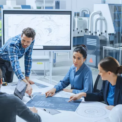 Engineers collaborating in a modern factory setting