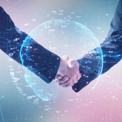 Handshake between business professionals with digital globe background