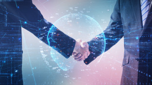 Handshake between business professionals with digital globe background